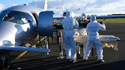 Medical staff take care of a patient infected with the Covid-19 disease upon his arrival from Saint-Etienne at Angers airport in Marce, western France. AFP