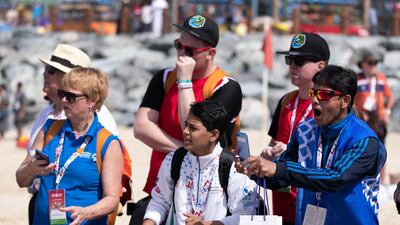Crowds cheer the athletes at the finish line at the Special Olympics World Games open water swimming competition in La Mer. Reem Mohammed / The National