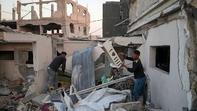 Gazans search through the rubble of their home in Jabalia, northern Gaza. It is estimated that more than 170,000 houses have been destroyed by Israel's bombardment of the enclave. Reuters