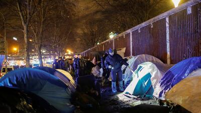 French police inspect tents during the evacuation. Reuters