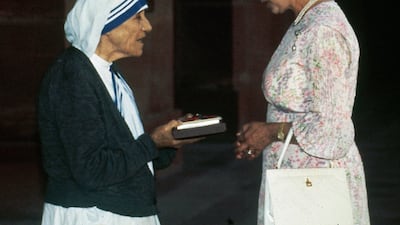Mother Teresa receives the Insignia of the Honorary Order of Merit from Queen Elizabeth in New Delhi. AP