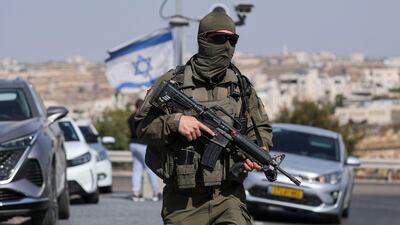 An Israeli soldier stands guard near the scene of the shooting in Hebron, in the occupied West Bank. Reuters