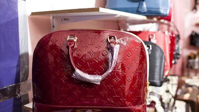 Counterfeit handbags designed by Louis Vuitton and Chanel sit on shelves of a secret room of a store at Karama Market in Dubai. Andrew Henderson / The National
