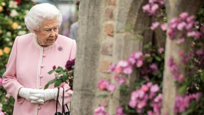 Britain's Queen Elizabeth II looks at a display of roses on the Peter Beale stand as she visits the 2018 Chelsea Flower Show in London. Richard Pohle / AFP Photo