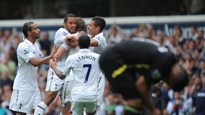 Tottenham Hotspur players celebrate with Belgian midfielder Mousa Dembele after his debut goal against Norwich City at White Hart Lane. Olly Greenwood/AFP