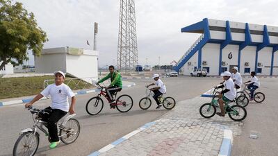 Students of Umm Al Quraa school take part in a cycling competition as part of the UAE national sports day at Al Arabi sports and cultural club in Umm Al Quwain. Pawan Singh / The National