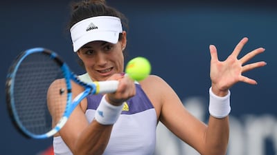 Garbine Muguruza returns the ball to Jennifer Brady. AFP