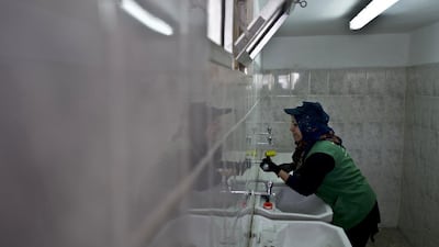 Jordanian plumber Maryam Mutlaq, 41, work on the faucets at a school in Zarqa, Jordan. Ms Mutlaq discovered during her training as a plumber that she loved handling tools and fixing things and has started carrying a few tools in her gray purse, in case a neighbor or relative needed a bit of plumbin. Muhammed Muheisen / AP Photo