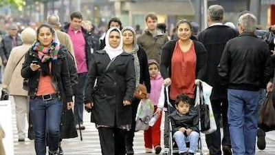 Turkish and German people walk on a shopping street in Gelsenkirchen, Germany. About 3 million of Germany’s 82.2 million people have Turkish roots.
