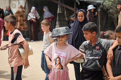 Displaced Palestinian children line up to receive food in Rafah in the southern Gaza Strip. AFP