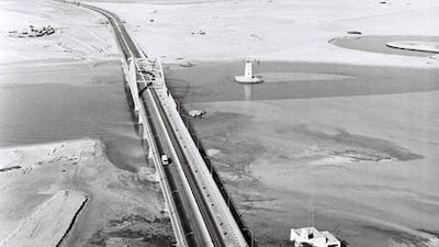An aerial shot of the empty land of southern Abu Dhabi island in 1967, and the newly built road and bridge that were a beginning to Abu Dhabi's future.