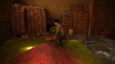 A child of a labourer uses a shovel to dry sweets inside its factory ahead of the Muslim festival Eid al-Adha or the 'Festival of Sacrifice', in Mazar-i-Sharif. AFP