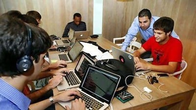 Rony El-Nashar, the SeedStartup founder, left, with Simone D'Amilo, from Metwit, right, during a mentoring session at the Pavilion Downtown Dubai. Antonie Robertson / The National