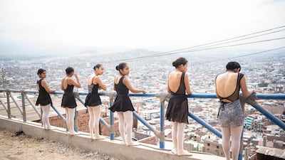 The students perform atop the hill in Chorrillos district