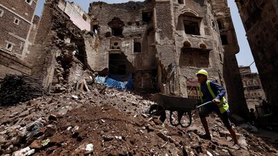 A Yemeni works on the site of rain-collapsed buildings in the old city of Sanaa. EPA