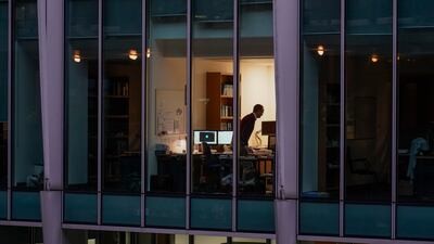 A worker in an office in London's financial district. Many people will start the year working from home amid government concerns about the spread of the Omicron coronavirus strain. AP