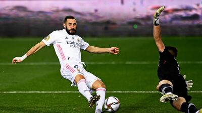 Real Madrid's Karim Benzema, left, scores past Athletic Bilbao goalkeeper Unai Simon. AP Photo