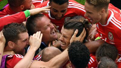 Wales forward Gareth Bale is mobbed after scoring during the Euro 2016 match against Slovakia at the Stade de Bordeaux in July 2016. AFP