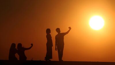 People take selfies during the last sunset of the year in Naypyitaw, Myanmar. AP Photo