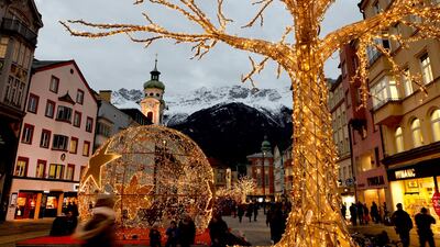 People pass by the Christmas illuminations in Innsbruck on December 15. Reuters