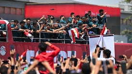 Egyptian fans cheer on the national team on an open-top bus after they have arrived at El Alamein International Airport. AFP