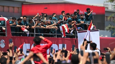 Egyptian fans cheer on the national team on an open-top bus after they have arrived at El Alamein International Airport. AFP