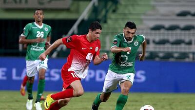 Al Jazira’s Abdelaziz Barrada, centre, tries to outpace Haydarov of Al Shabab in Dubai. Pawan Singh / The National