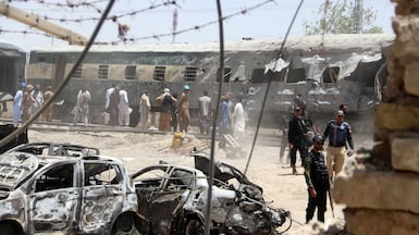 Security officials and rescuers inspect the widespread damage at the scene of a deadly bomb blast on a train in Quetta, Pakistan. EPA