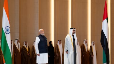 Sheikh Mohamed and Mr Modi stand for the national anthems. Abdulla Al Bedwawi / Presidential Court