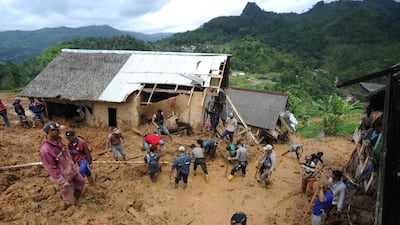 Rescuers search for victims at a village hit by a landslide in Sirnaresmi, West Java, Indonesia. AP Photo
