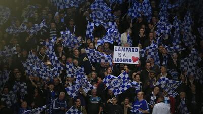 Chelsea fans hold up a sign reading "Lampard is a legend" and flags ahead of Tuesday night's Champions League match between Chelsea and Paris Saint-Germain. Adrian Dennis / AFP / April 8, 2014