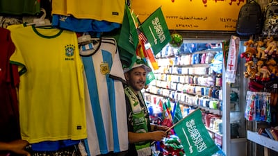 A stallholder in the Souq Waqif market area selling World Cup paraphernalia during the Fifa World Cup 2022 in Qatar. EPA