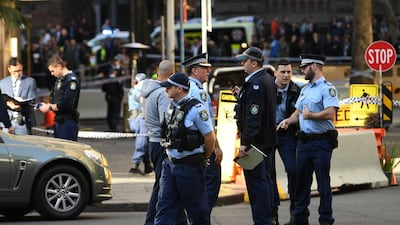 Police gather at the crime scene after a man stabbed a woman and attempted to stab others in central Sydney. AFP