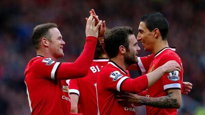 Wayne Rooney, left, is congratulated by his teammates after scoring Manchester United's second against Aston Villa. Alex Livesey / Getty