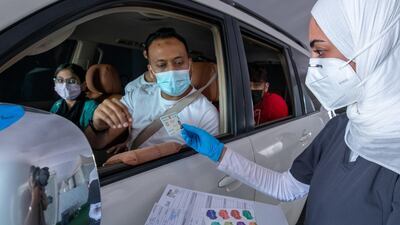 Ms Al Badi goes through the vaccination process with a driver.