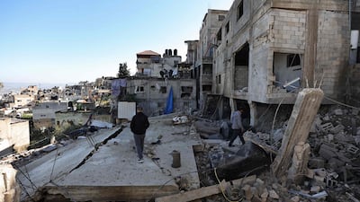 Men walk amid the rubble of a building destroyed during an Israeli army operation in the Jenin refugee camp in the West Bank. AFP