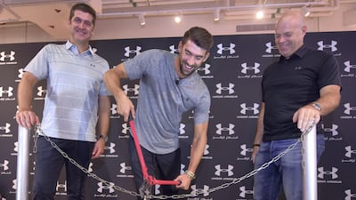 Swimming champion Michael Phelps cuts the chain at the grand opening of the Under Armour store at Dubai Mall. Under Armour