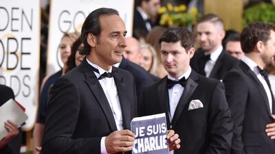 Alexandre Desplat holds a sign reading “Je suis Charlie” AP