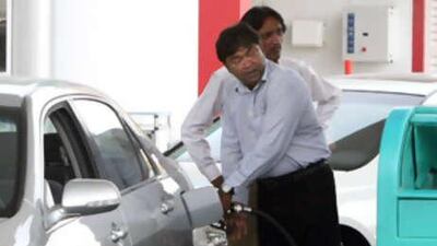 Do it yourself: Charles Kenneth, a businessman who lives in Sharjah, pumps petrol at the Enoc off Jumeirah Beach Road in Dubai.