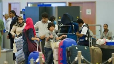 Travellers go through a security check point at Dubai International Airport Terminal 2 in Dubai. Amy Leang/The National