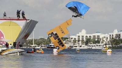 A team of teachers from Nord Anglia school launch their home-made school bus off a six-metre high flight deck during the Red Bull Flugtag event at Dubai Creek Park. Sarah Dea / The National