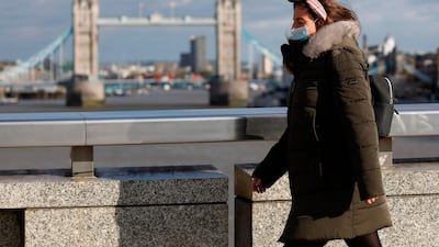 A pedestrian at London Bridge on September 25, 2020. Britain's Prime Minister Boris Johnson announced a host of new restrictions as Covid-19 cases spike. Tolga Akmen / AFP