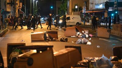 Protesters block a street with bins in Colombes. AP
