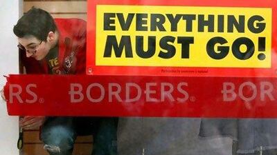 GLASGOW, SCOTLAND - DECEMBER 22: A member of staff removes a sign in the Borders book store window in Buchanan Street on December 22, 2009 in Glasgow, Scotland. All 45 Borders stores will close today due to the economic downturn and the increase in competition from internet retailers and supermarket chains. (Photo by Jeff J Mitchell/Getty Images) *** Local Caption *** GYI0059187346.jpg