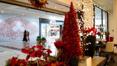 Red Christmas trees in the window display of a home store in Riyadh, Saudi Arabia. Bloomberg