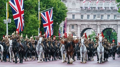 Troops of the Household Cavalry march on The Mall in central London. PA