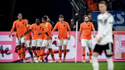 Netherland's Virgil Van Dijk, left, celebrates with teammates after scoring against Germany during their Uefa Nations League match. EPA