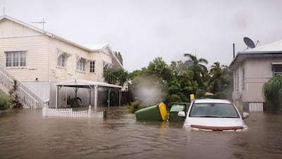 A semi-submerged car outside a home in Rosslea, Townsville following days of heavy monsoonal rains. EPA