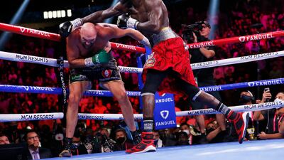 Deontay Wilder swings at Tyson Fury as the battle continuedn into round nine. AP