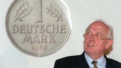 Hans Tietmeyer, seen with the German mark, was instrumental in developing the euro. Uwe Zucchi / AFP